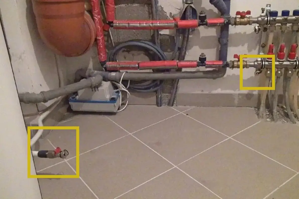 Rohrleitungen mit Ventilen, bereit zum heizung wasser ablassen. Ein kleiner Hahn ist hervorgehoben.